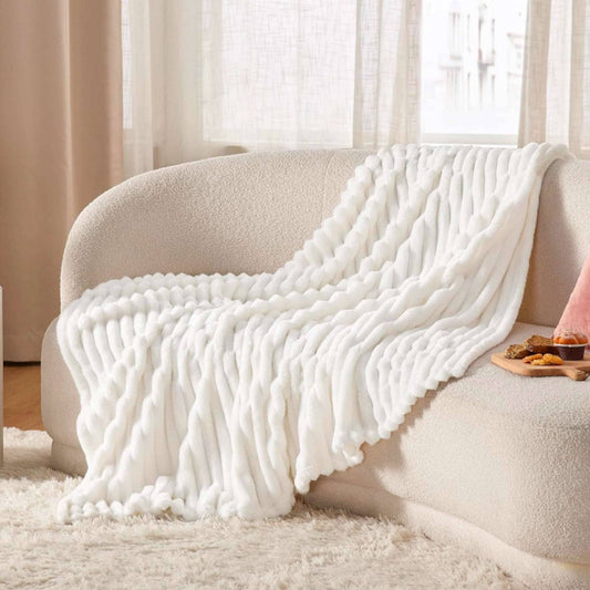 Dabble Doll white cozy knit blanket in thoughtful pampering gift for her gift box on cream sofa