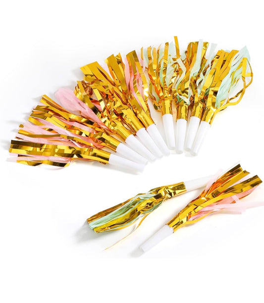 Gold and white noisemakers with colorful tassels on a white background