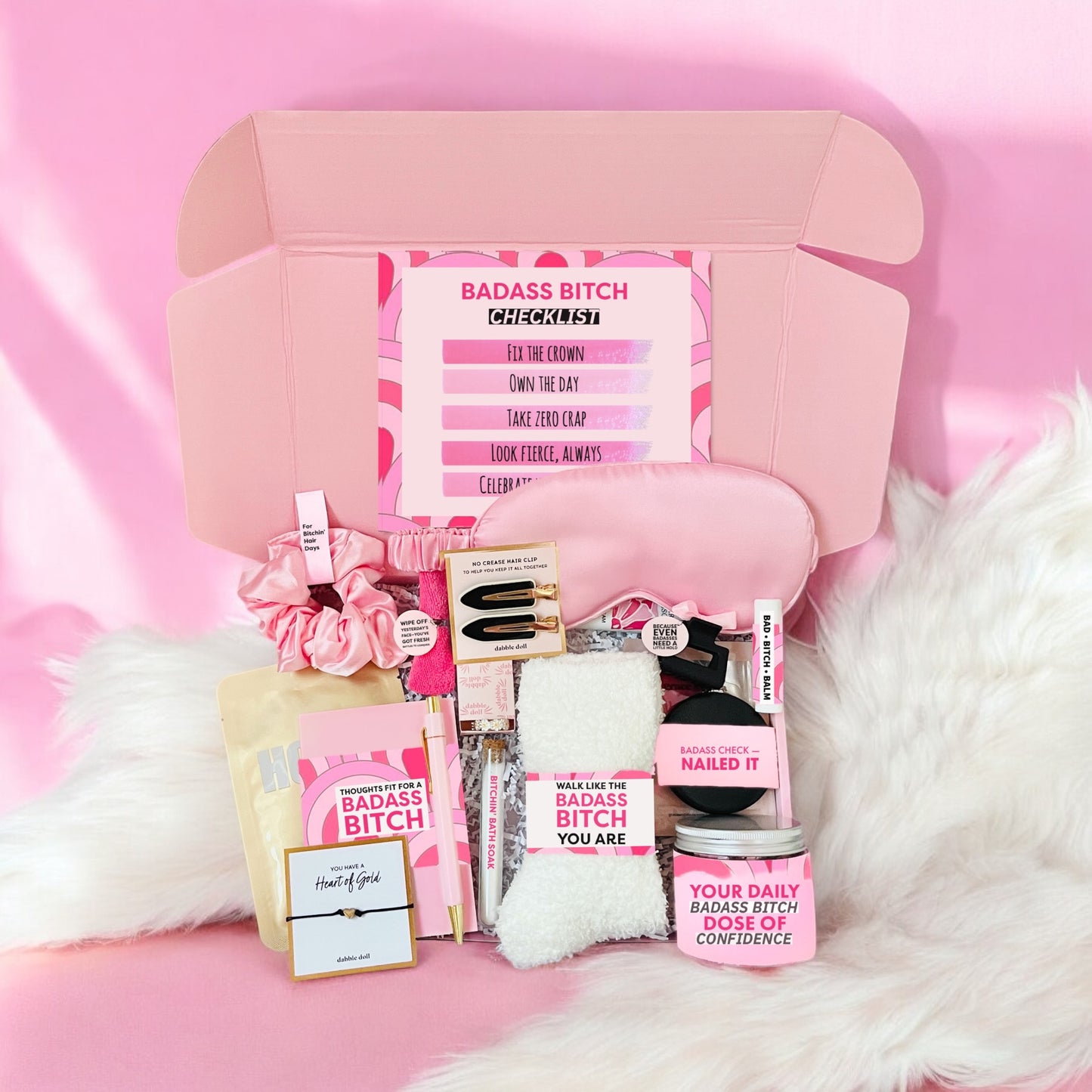 Dabble Doll badass bitch gift box with pink self-care items and confidence boosters in an open box