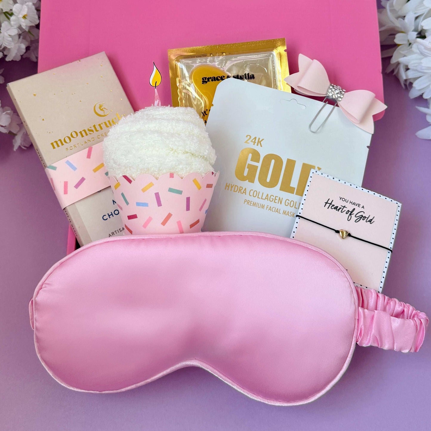 Dabble Doll birthday gift socks box with pink silk eye mask, face masks, towel, and bracelet