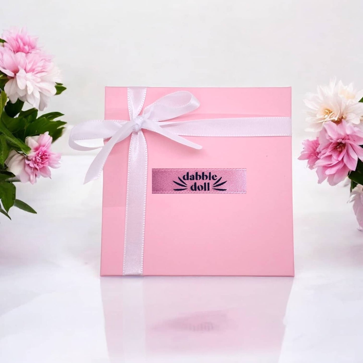 Dabble Doll gift box with ribbon, perfect for charm and necklace presentation