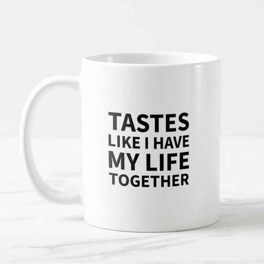 Dabble Doll coffee mug with bold text stating TASTES LIKE I HAVE MY LIFE TOGETHER