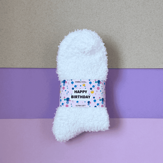 Dabble Doll gift box featuring ultra soft cozy socks with a Happy Birthday label