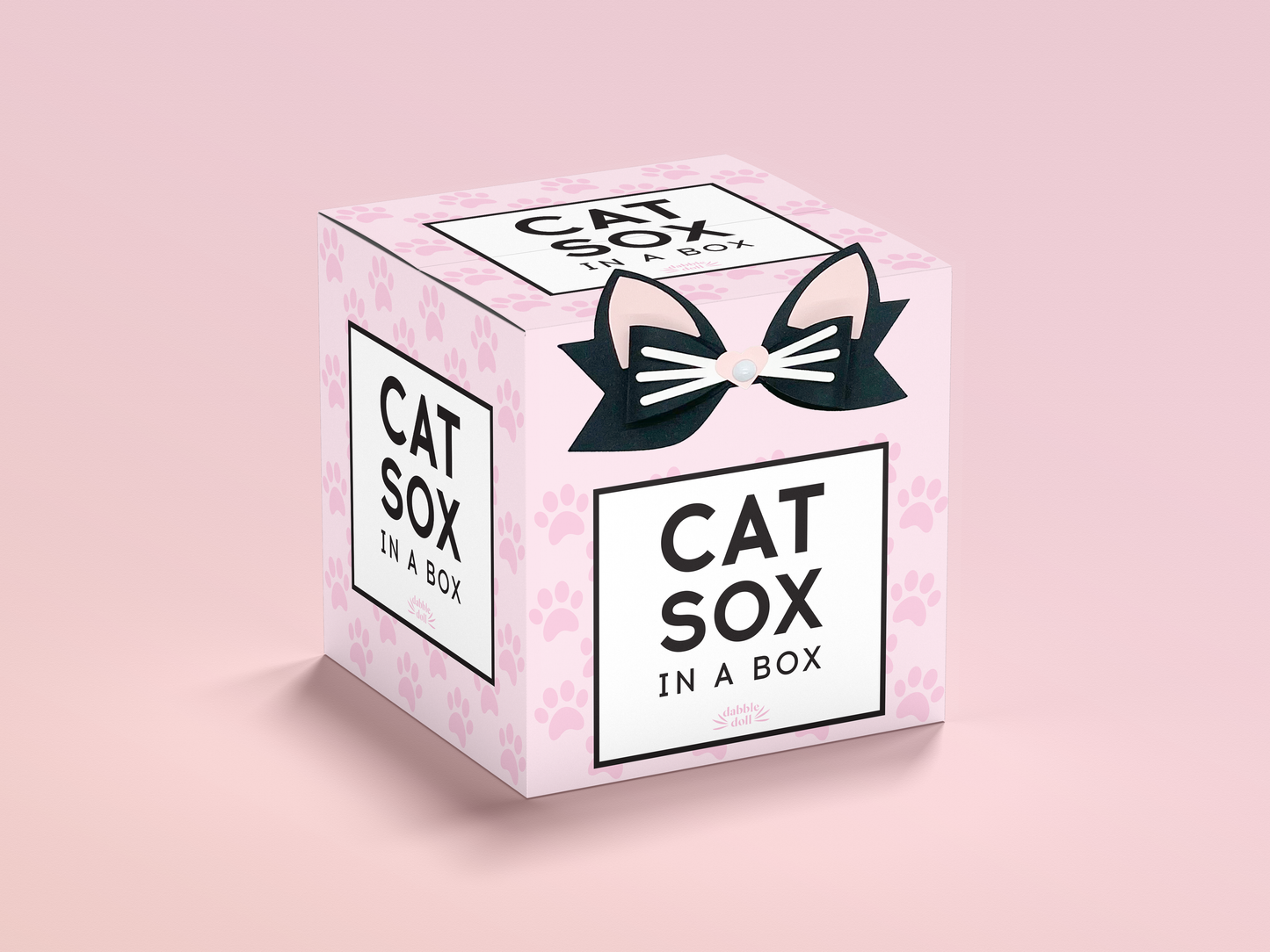 Pink box packaging for Dabble Doll cute pink cat socks featuring cat ears and paw prints design
