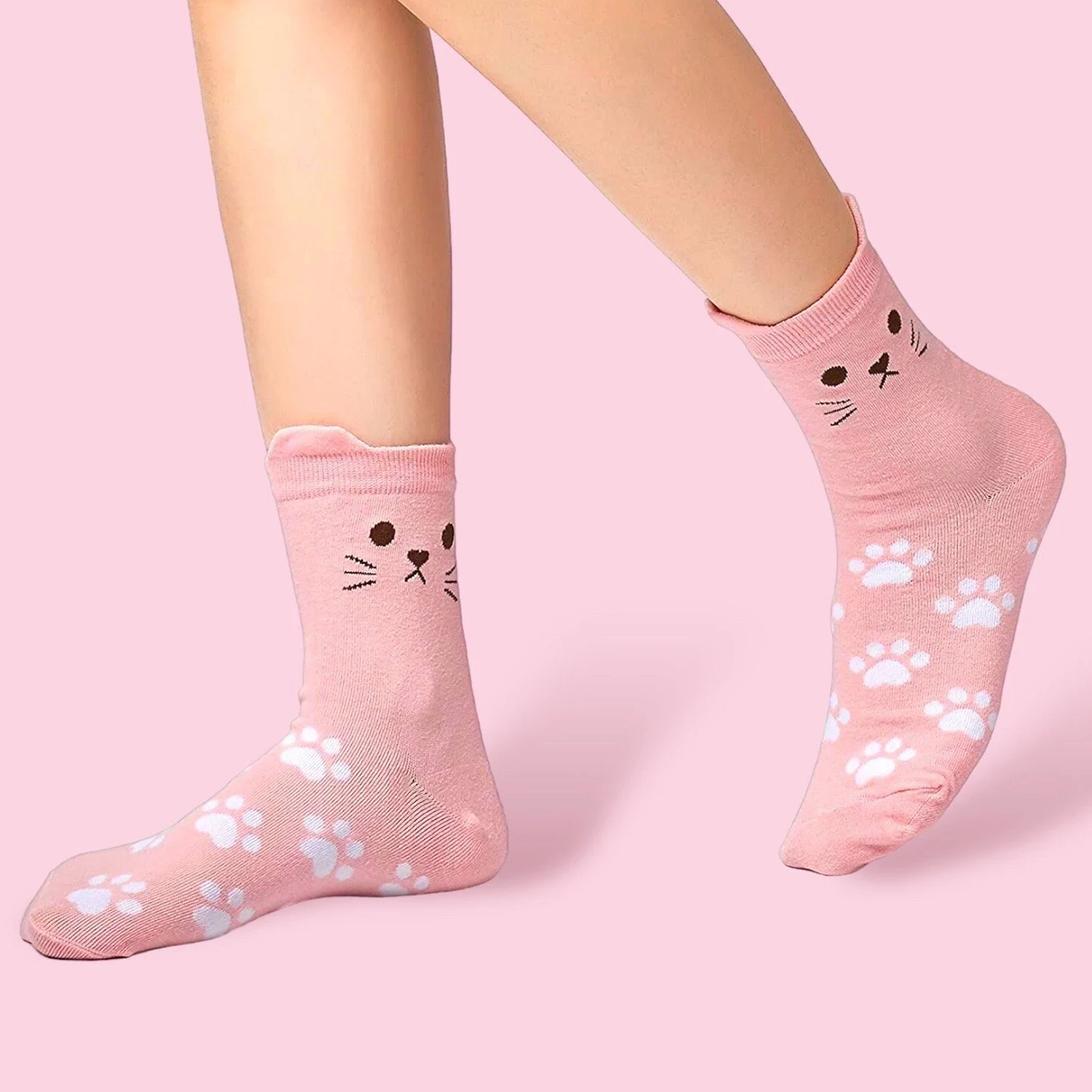 Cute pink cat socks with paw prints and cat face design by Dabble Doll on model feet