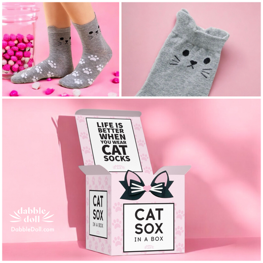 Gray cat socks gift box with cute cat face and paw prints socks packaged in pink box by Dabble Doll
