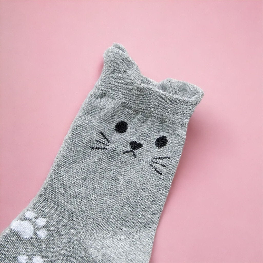 Gray cat socks with cute face and paw print detail from Dabble Doll cat socks gift box