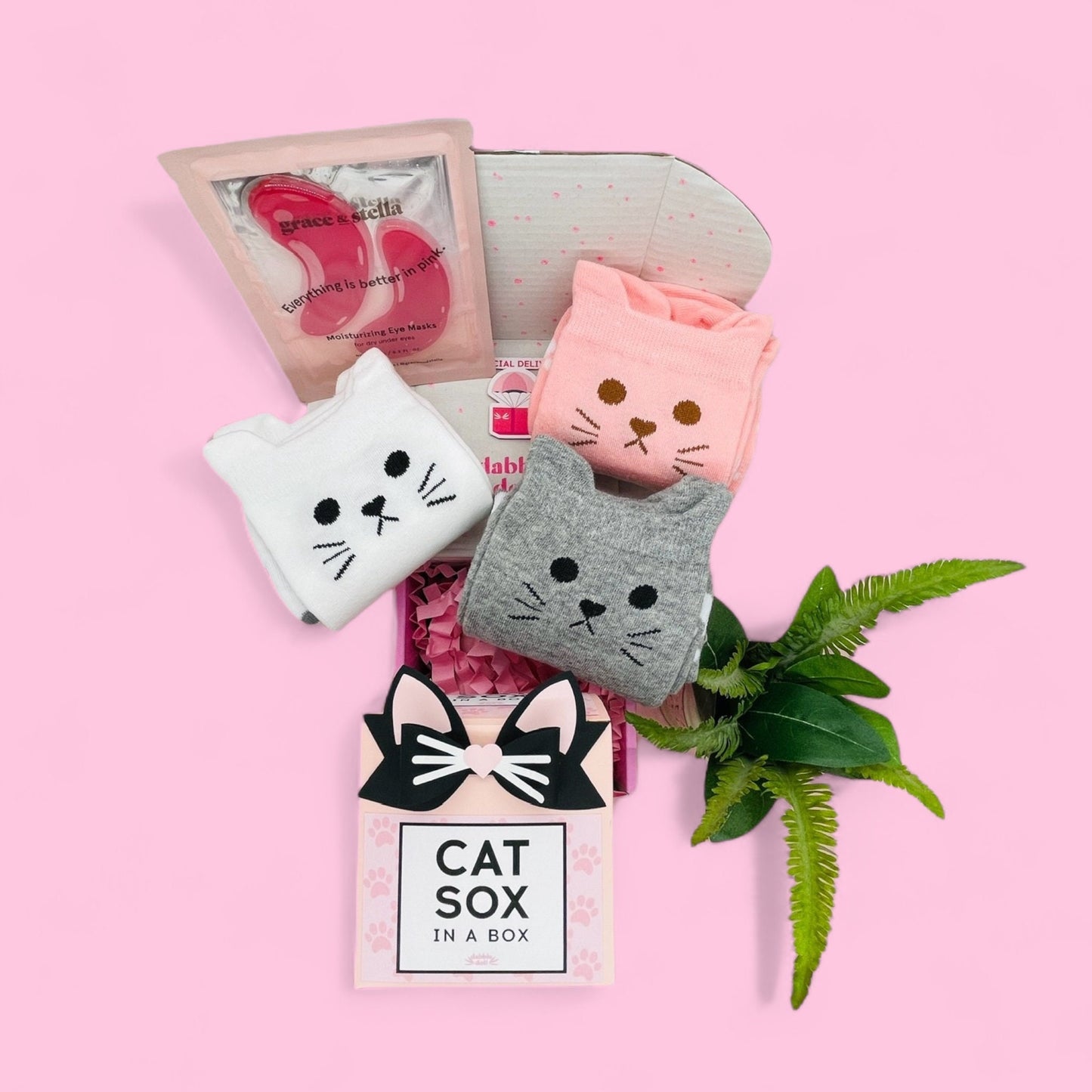 Dabble Doll cat socks gift box with three colorful cat face socks and a heart-shaped accessory