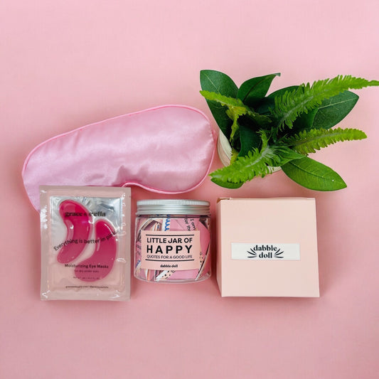 Dabble Doll happy jar gift set with eye masks pink sleep mask and decorative plant on pink background