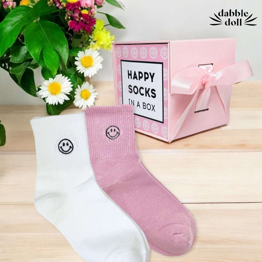 Happy socks gift box by Dabble Doll with white and pink smiley face socks and pink ribbon box
