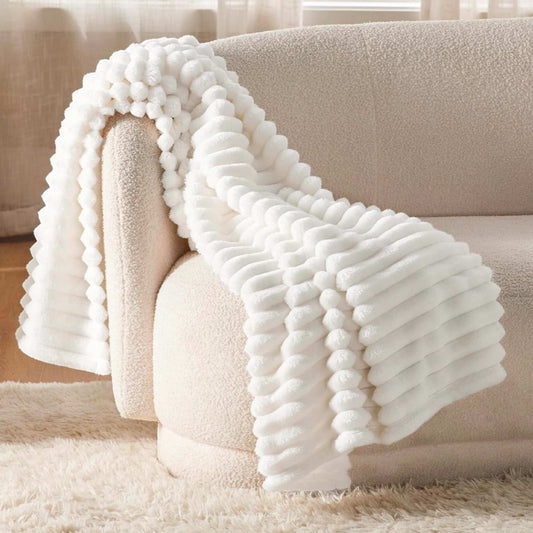 Cozy white textured throw blanket on beige sofa from hygge gift box for her by Dabble Doll