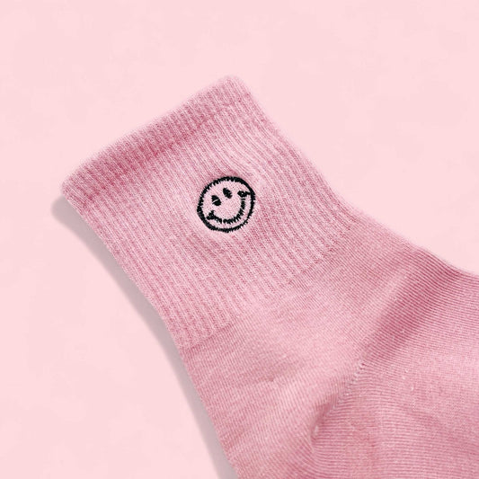 Pink sock with black embroidered smiley face detail included in Mini Valentines gift box