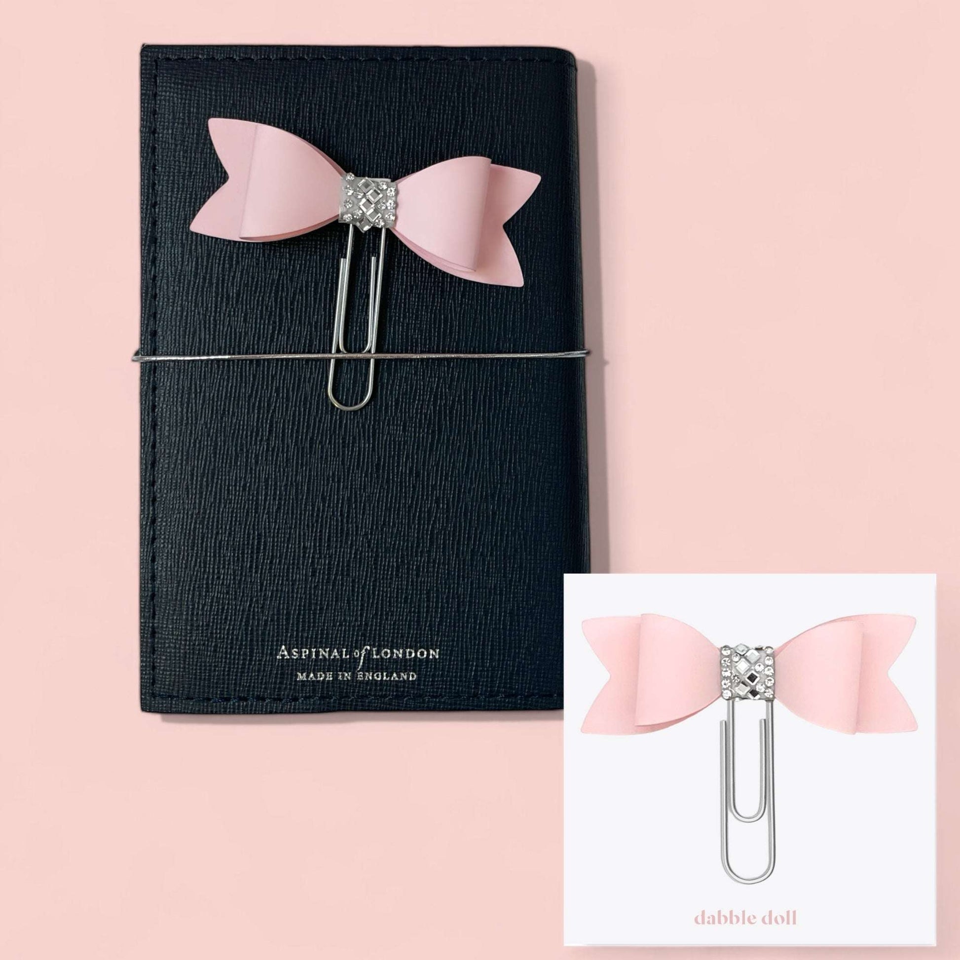 Pink spa gift box for her featuring a pink bow paperclip on a black textured notebook