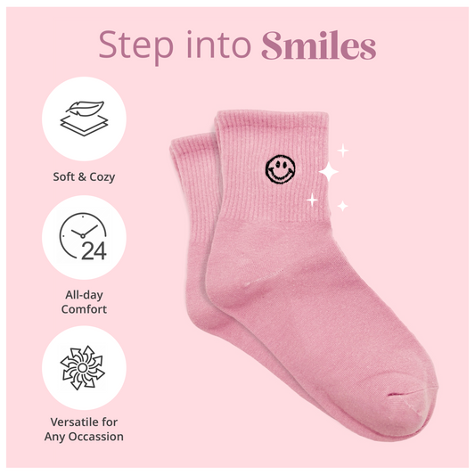 Dabble Doll pink socks with smiley face design included in self-care gift box for women