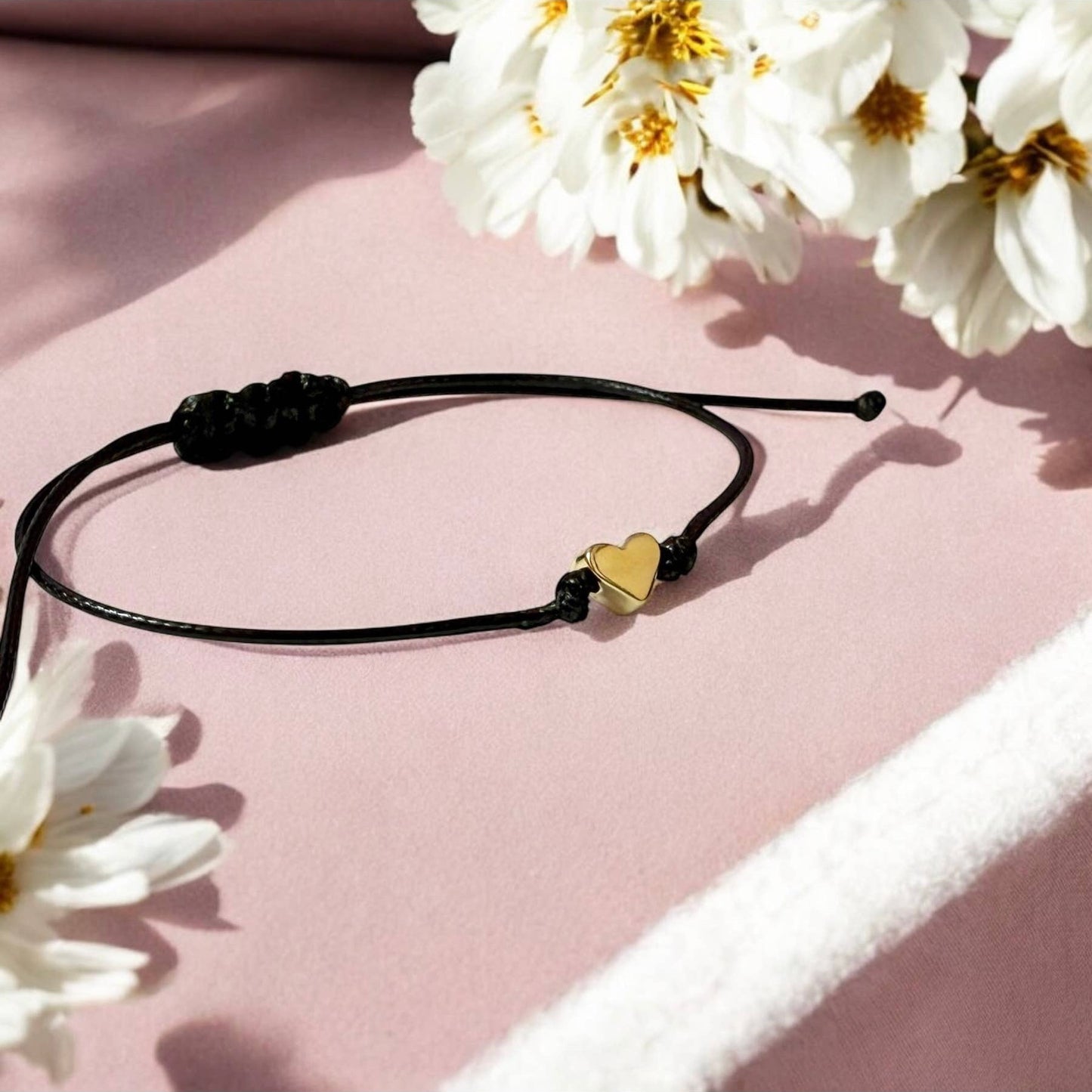 Dabble Doll gift box featuring a black bracelet with a heart charm, perfect for saying thinking of you