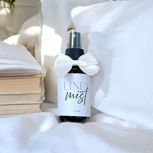 Dabble Doll Gift Box featuring a scented linen mist in a stylish black bottle with a white bow, perfect for women