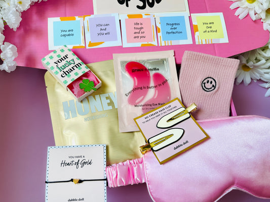 Pink gift box from Dabble Doll filled with skincare items, perfect for girls and women