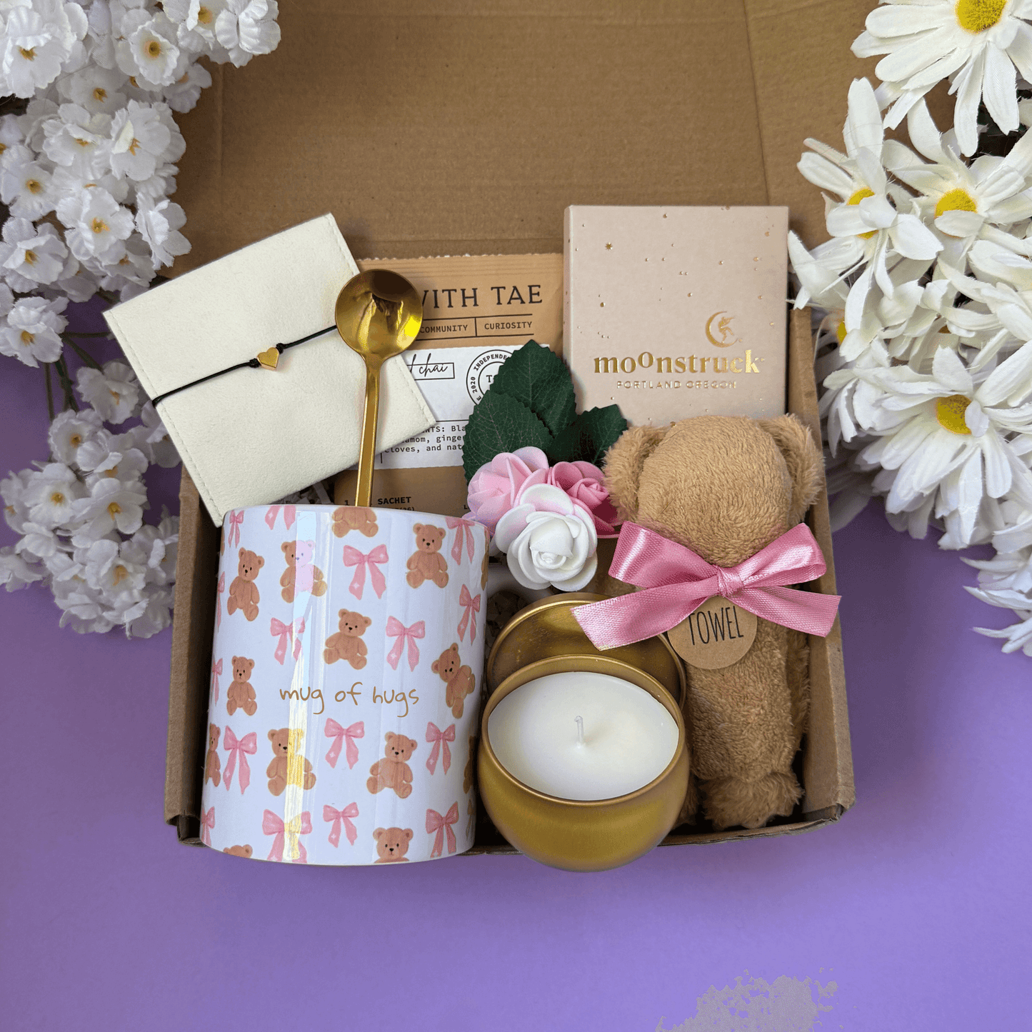 Dabble Doll gift in box featuring a candle, teddy bear, mug, and decorative items for a thoughtful present