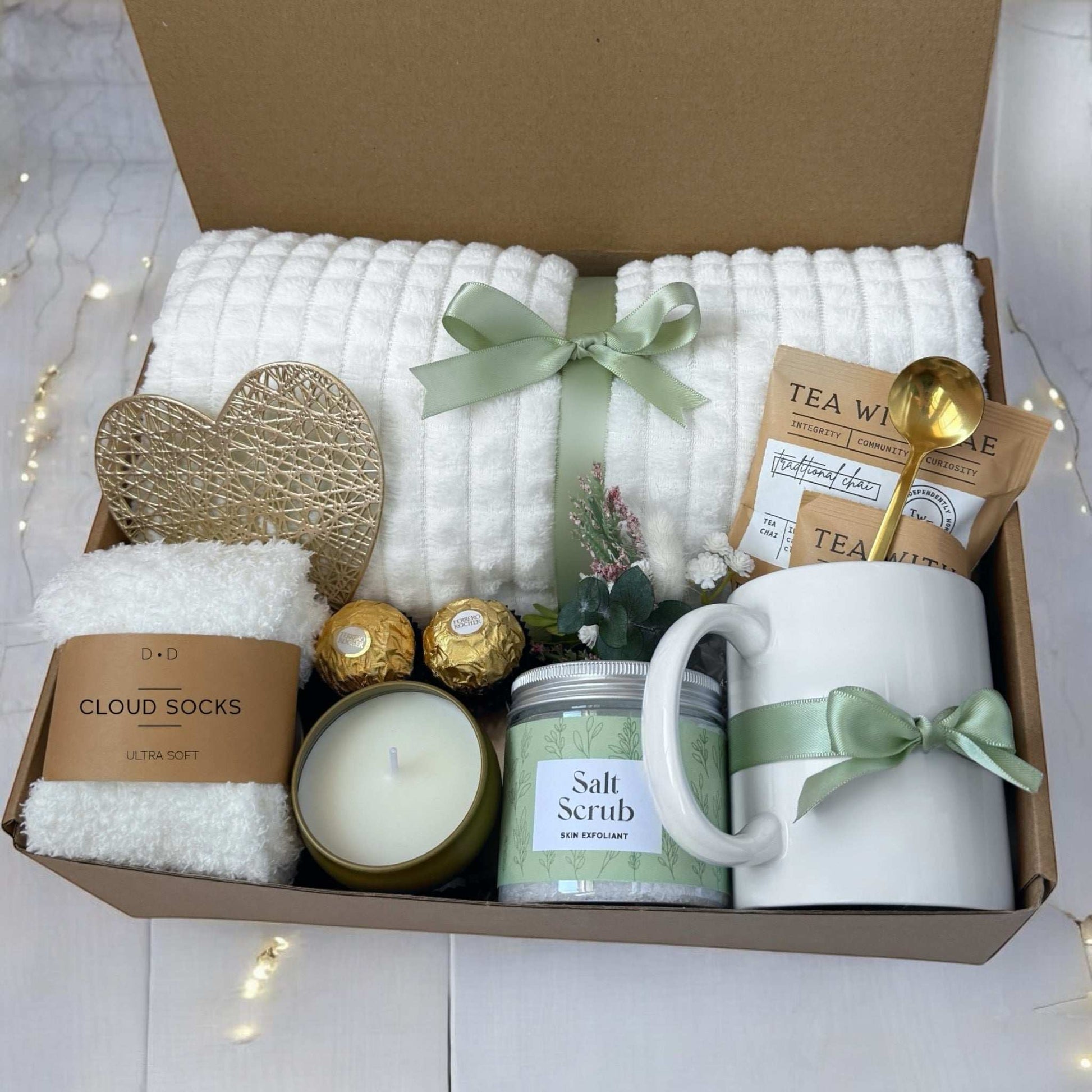 Dabble Doll hygge gift box for women with cozy socks, salt scrub, candle, tea, mug, and decorative heart