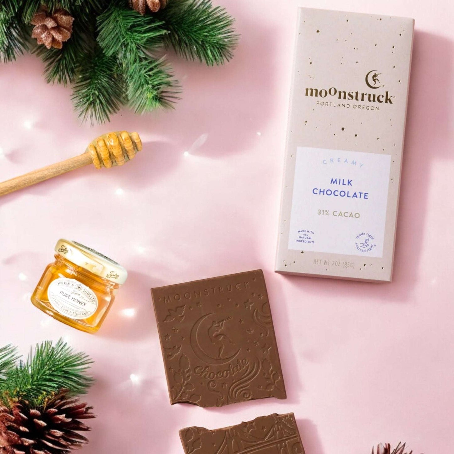 Dabble Doll self care gift box for her featuring creamy milk chocolate bar and honey jar with festive greenery