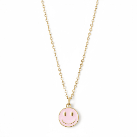 Dabble Doll necklace smiley face in gold with a pink enamel charm for cheerful style
