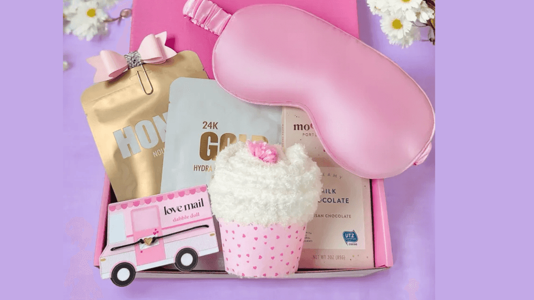 Pink sympathy gifts box for women with an eye mask, cupcake plush, and skincare items for comfort