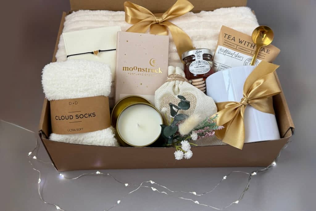 Self-care gift boxes for women featuring soft cloud socks, a soothing candle, and luxurious spa treats