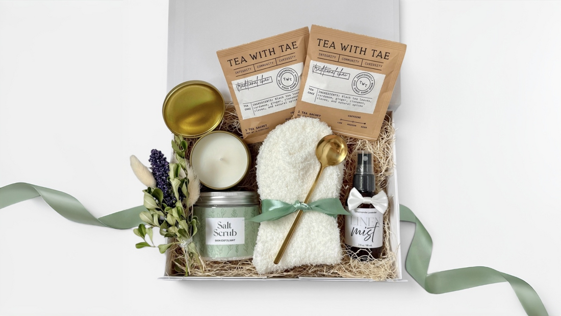 gifting hamper idea with candles, cozy socks, and treats arranged in a custom box