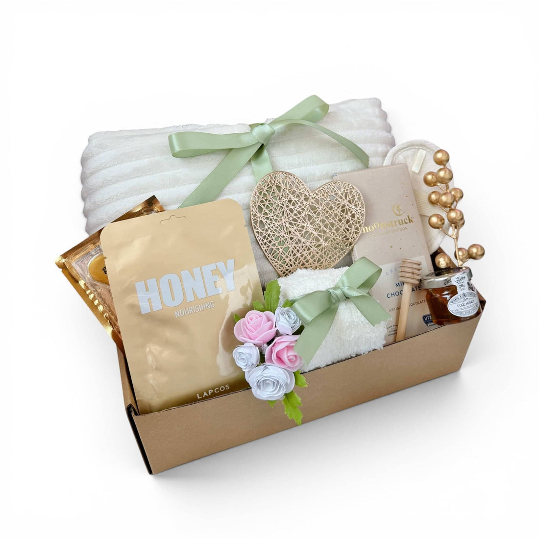 Thoughtful thinking of you gift box for women featuring soft blanket, skincare, and decorative flowers