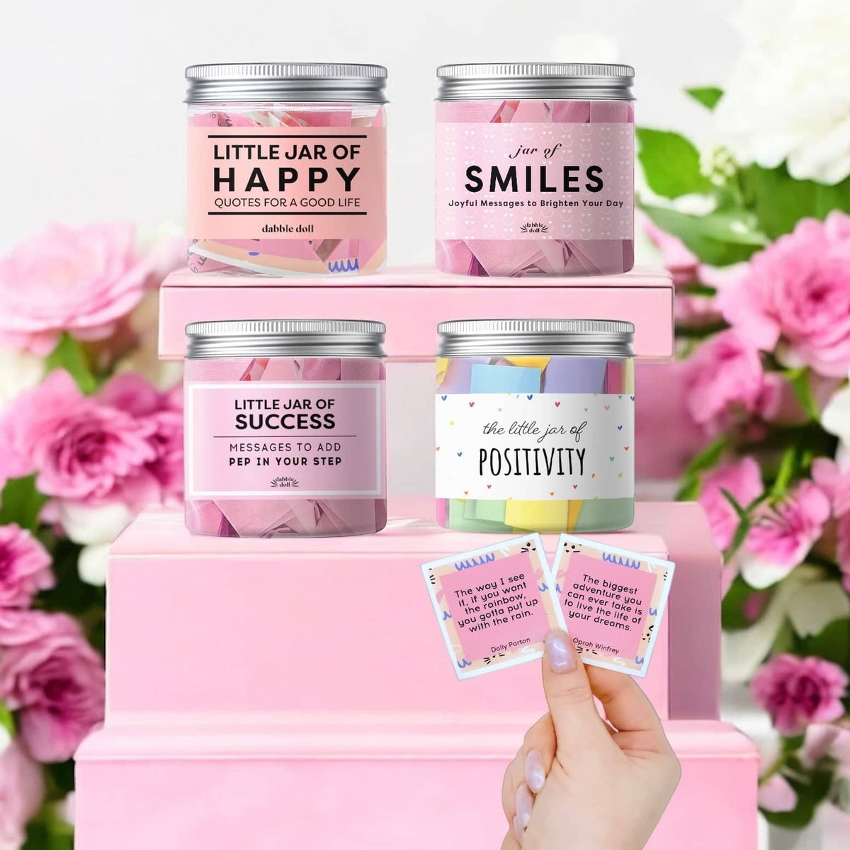 Motivational message jars with affirmations and quotes including happiness, smiles, success, and positivity in pink setting