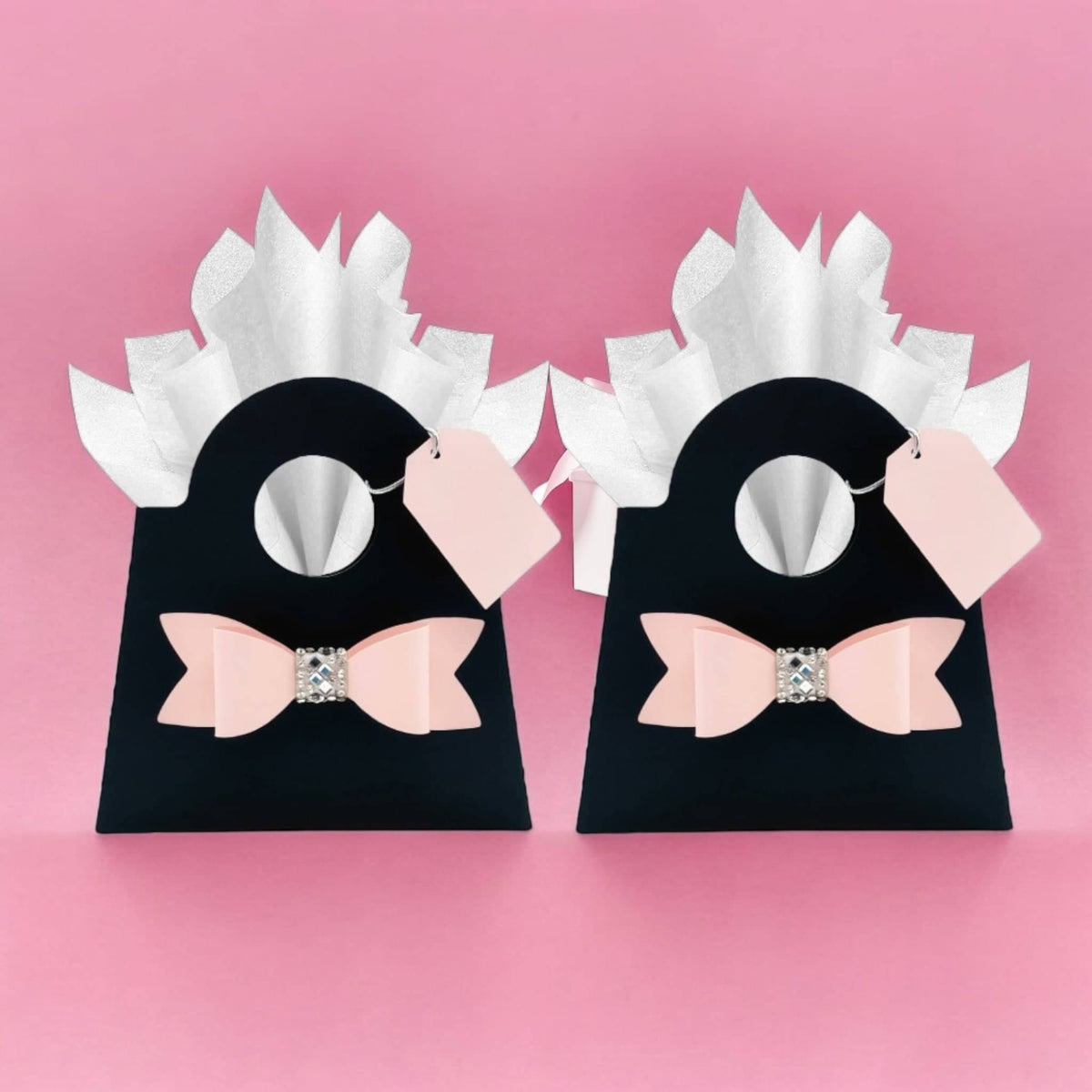 Elegant gift bags for girls and women in black with pink bows and white tissue, perfect for parties and celebrations