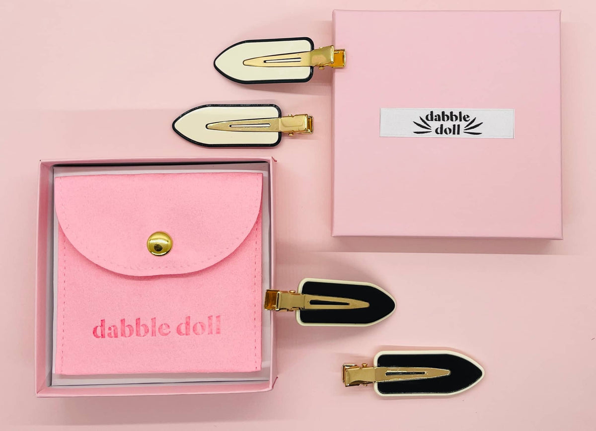 Thoughtful accessory gifts for her featuring cute hair clips and a pink pouch in stylish packaging