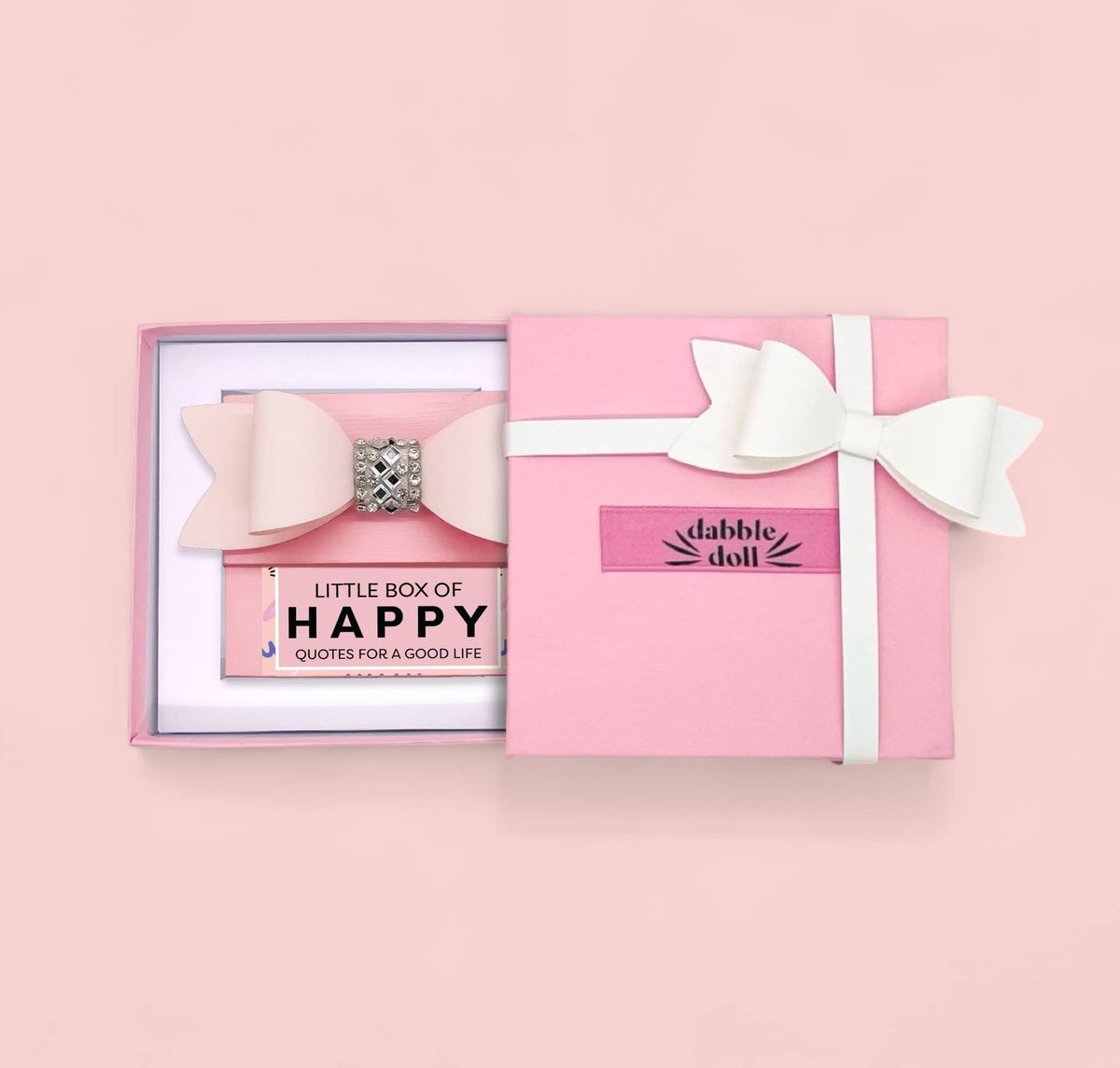 Inspirational gift ideas for her featuring a pink box with a white bow and a motivational quote card inside