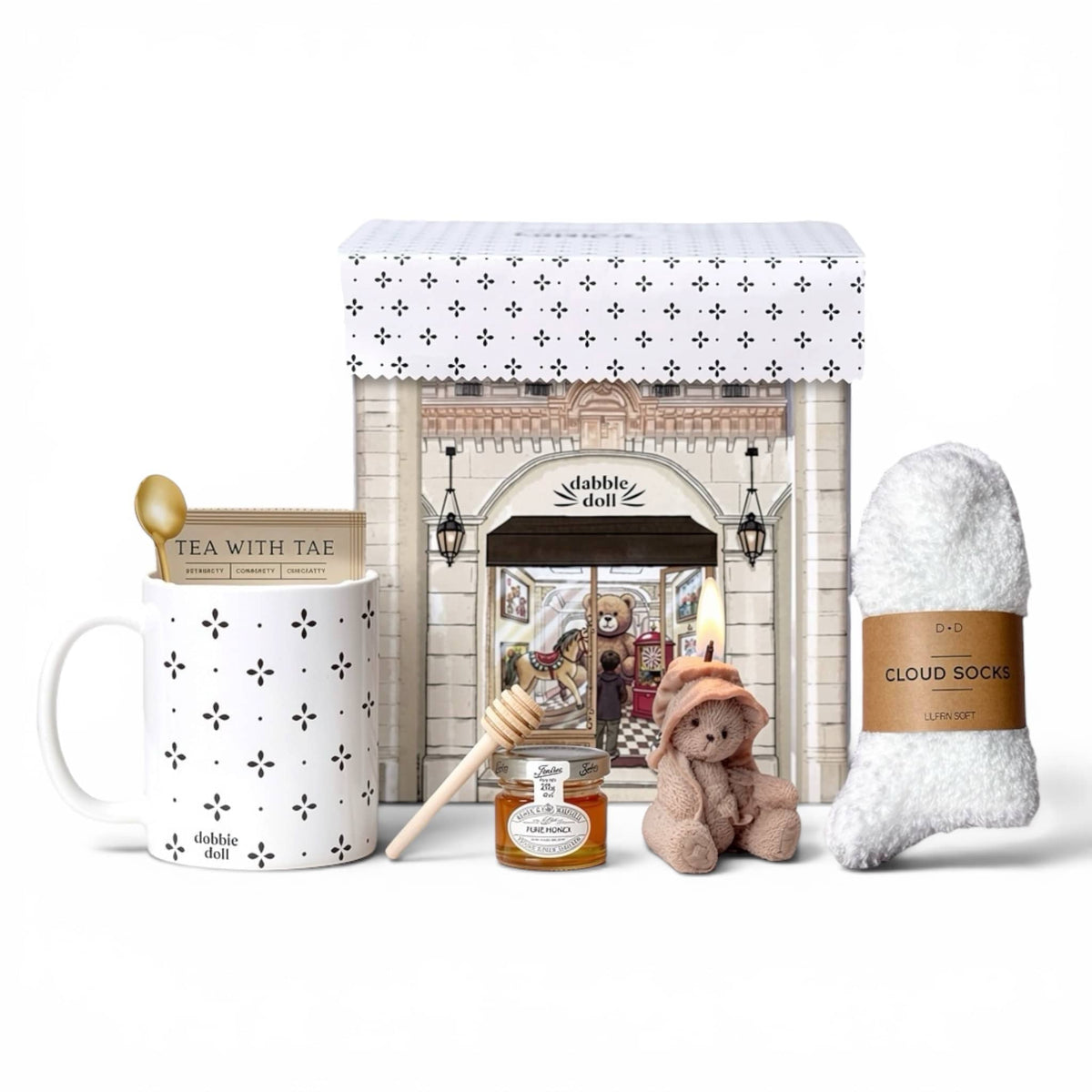 Collection of items including a mug, teddy bear, and cloud socks on a white background