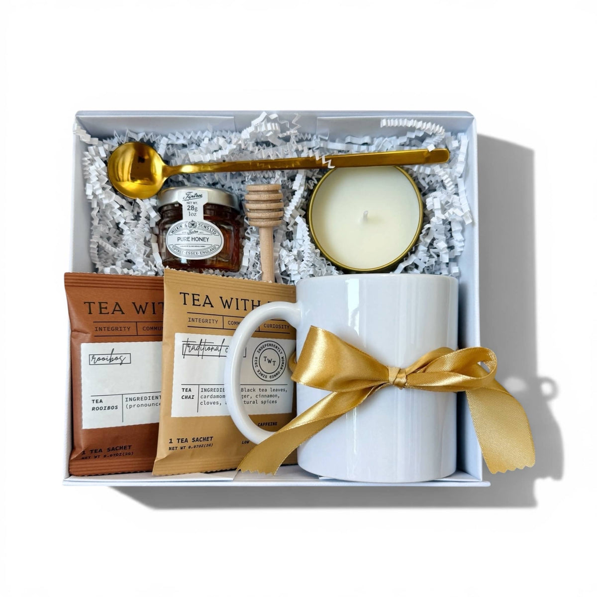 Dabble Doll gift box in elegant white with tea, honey, candle, and a personalized mug for women