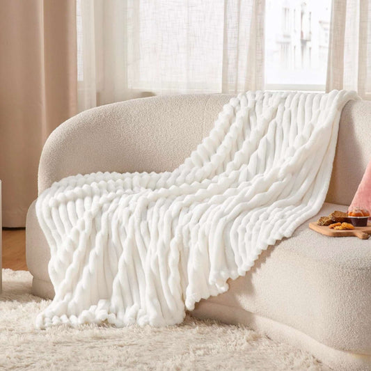 Dabble Doll white cozy knit blanket in thoughtful pampering gift for her gift box on cream sofa