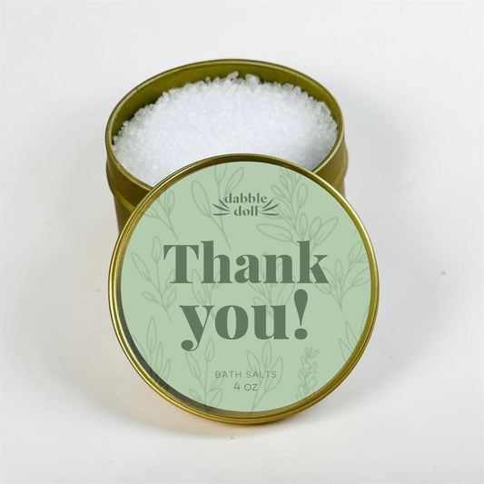 Bath salts in a gold tin with a 'Thank you!' label on a white background