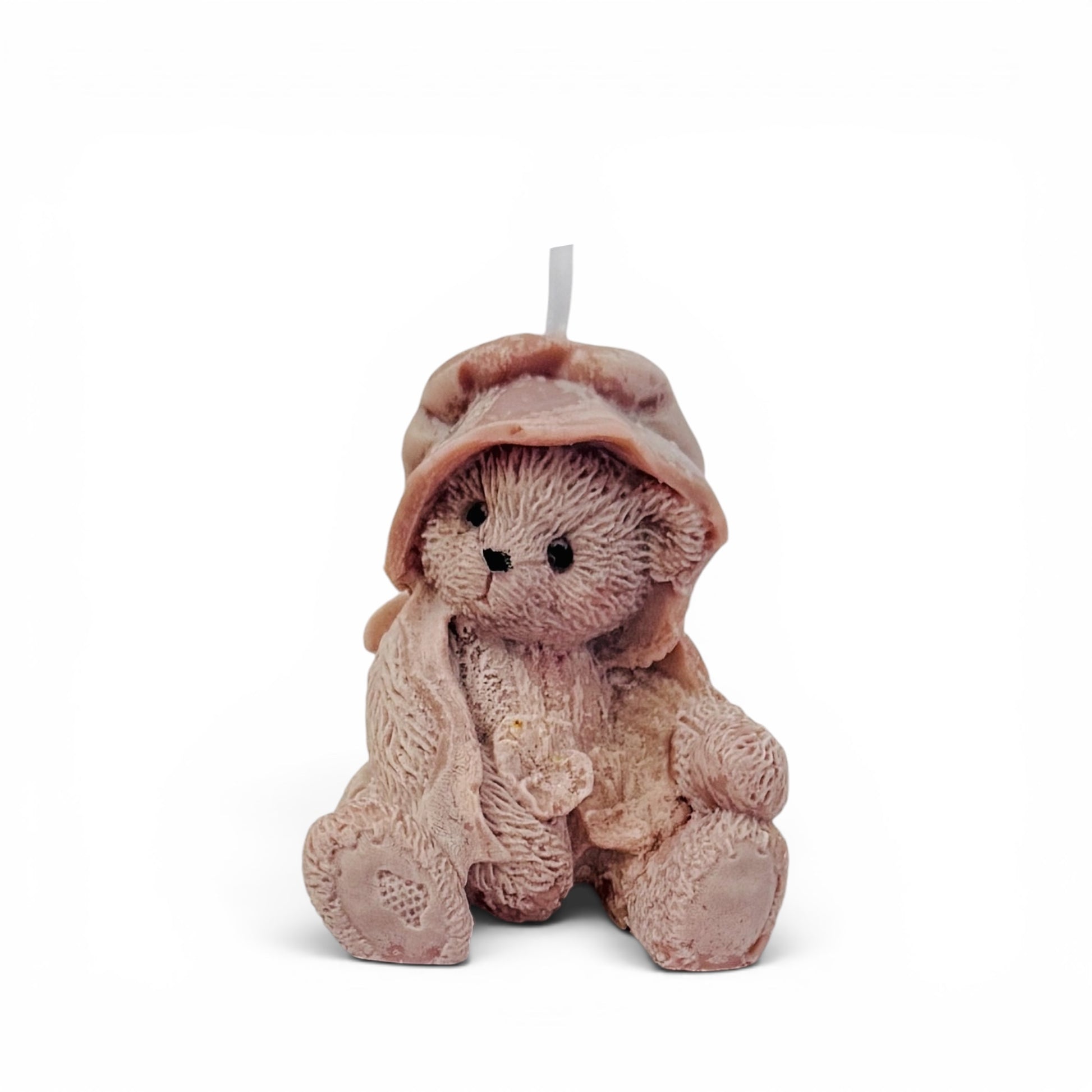 Teddy bear candle in a hooded robe on a white background