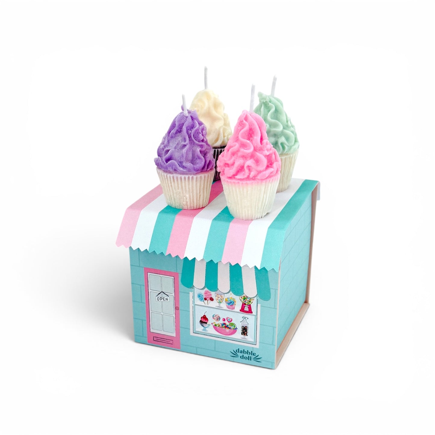 Pastel-colored cupcake candles in a decorative box with a striped awning on a white background
