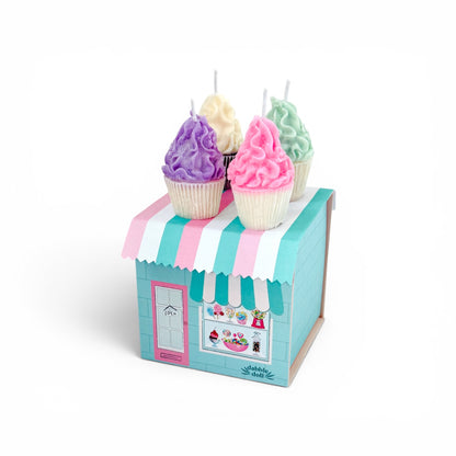 Pastel-colored cupcake candles in a decorative box with a striped awning on a white background