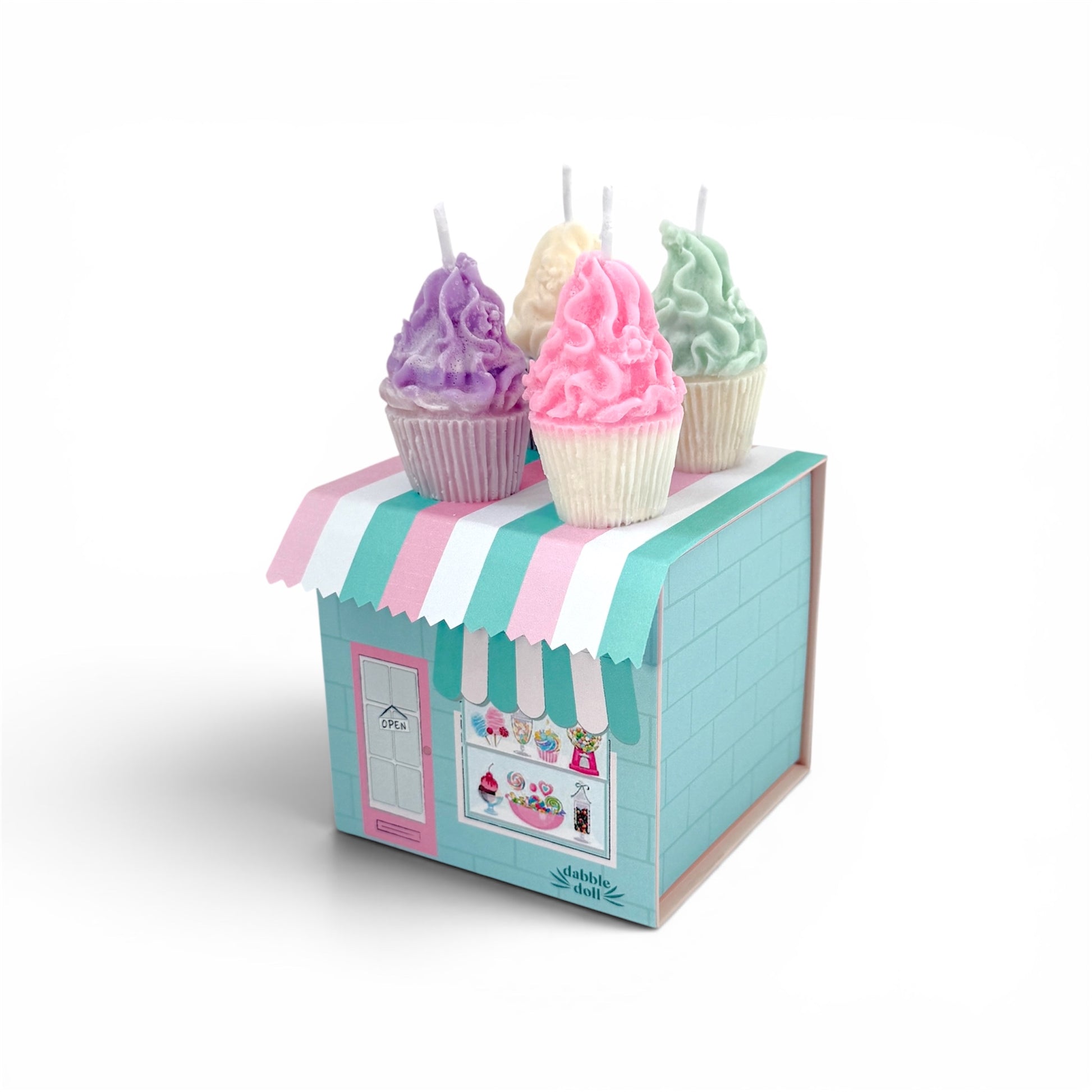 Pastel-colored cupcake candles on a small cardboard stand with a striped awning.
