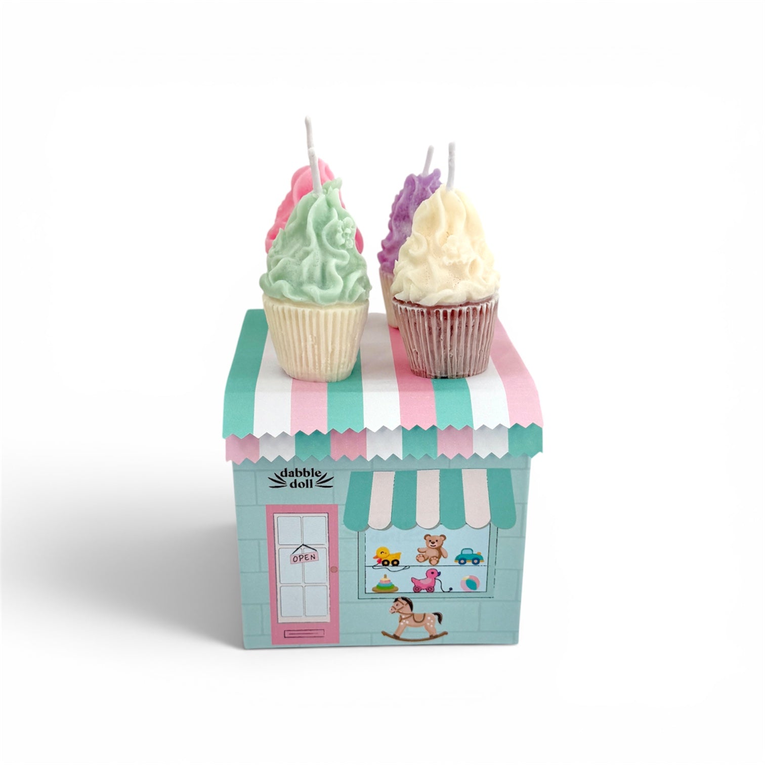 Candle set in cupcake shapes on a box with a striped roof, featuring the brand 'claddagh doll'.