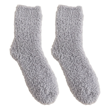 Pair of gray fuzzy socks on a white background