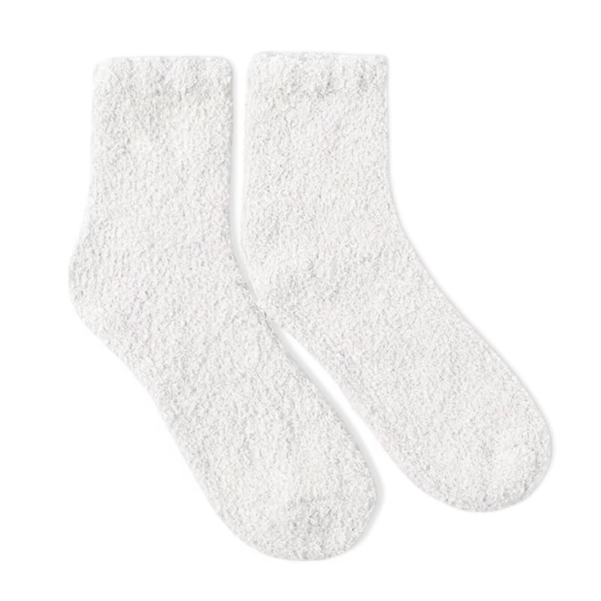 Pair of white fuzzy socks on a white background