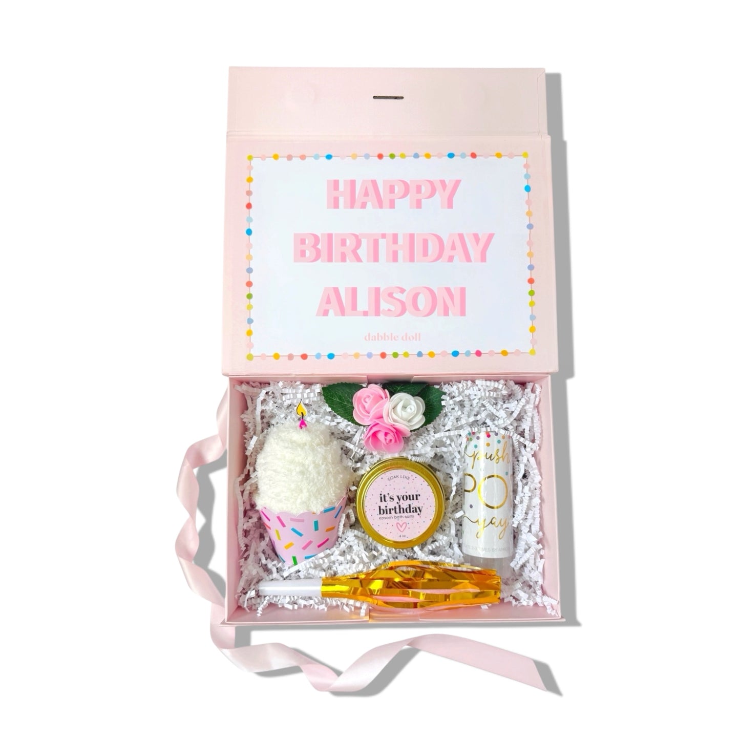 Gift box with birthday-themed items and a card inside