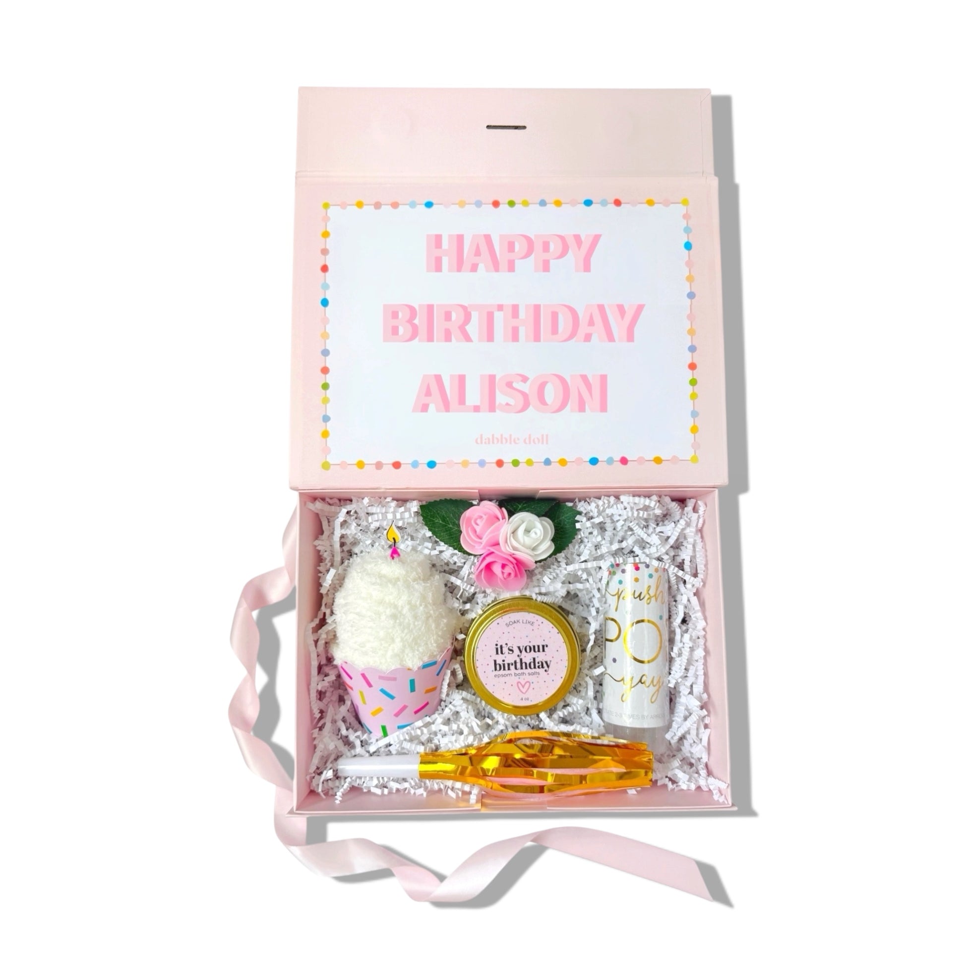 Gift box with birthday-themed items and a card inside