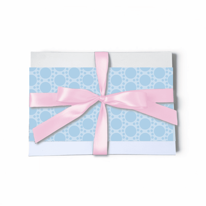 Gift card with blue polka dot pattern and pink ribbon on a white background