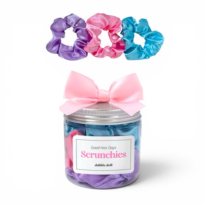 Jar of scrunchies with a pink bow on a white background
