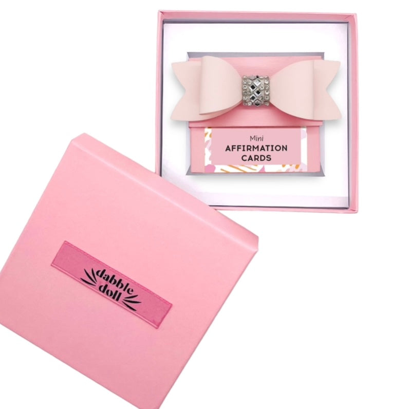 Pink Dabble Doll affirmation cards in an elegant box, designed for girls and women with a decorative bow