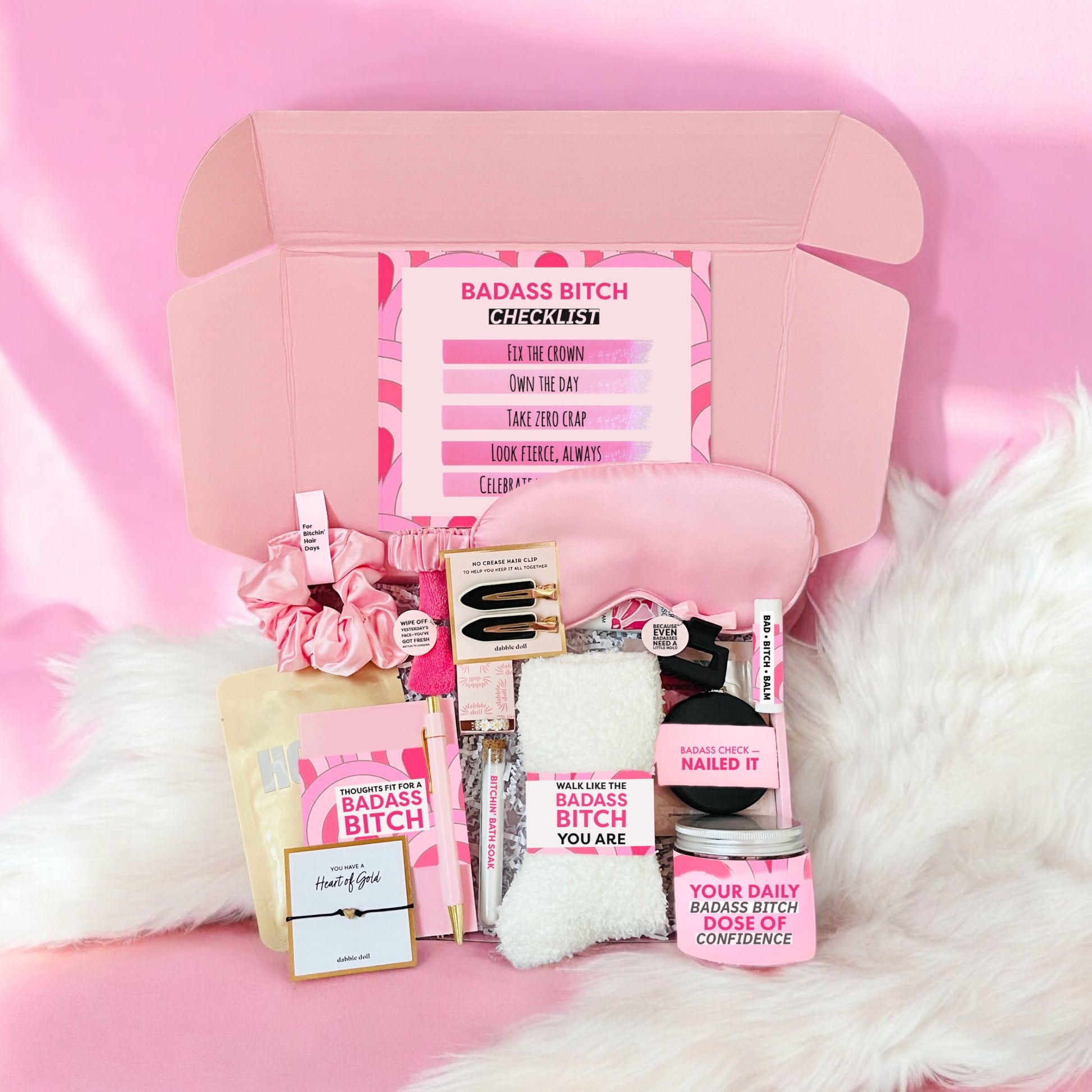 Dabble Doll badass bitch gift box with pink self-care items and confidence boosters in an open box